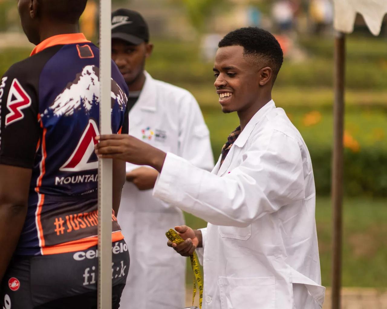 Image of a nurse in a white coat in conversation with a man.