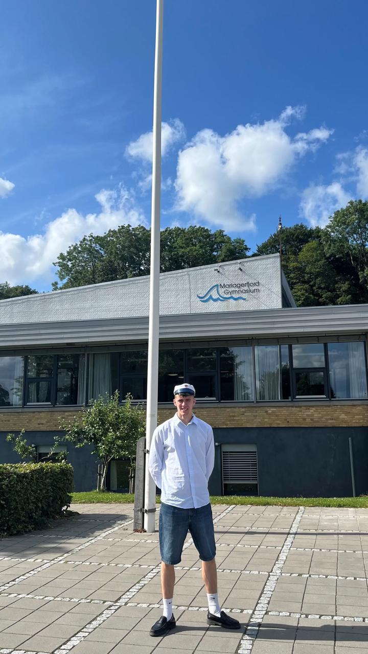 William står som student foran en flagstang