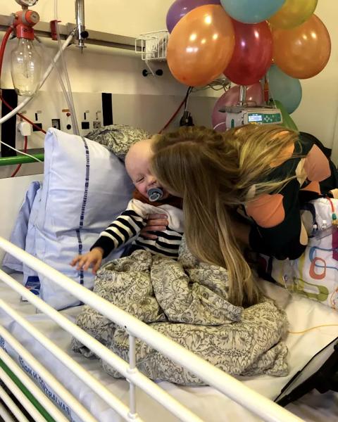 Vitus smiler i hospitalssengen, imens han får et stort kram af sin mor 