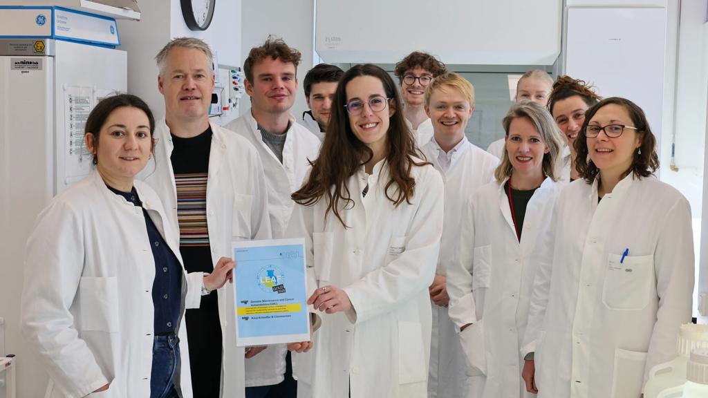 Members of the Mailand lab holding their Gold LEAF certificate to recognise sustainable lab practices.​